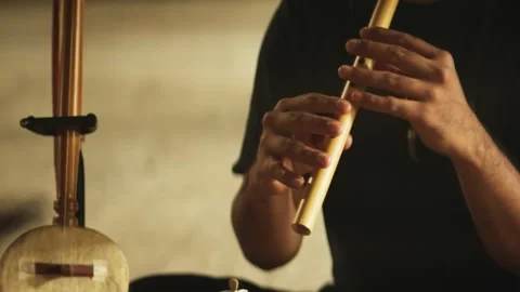 Playing traditional bamboo flute suling Stock-Footage 345860301