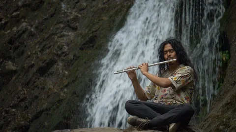 Playing trumpe in a waterfall Stock Footage 119100877