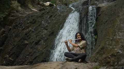 Playing trumpe in a waterfall Stock Footage 119190897