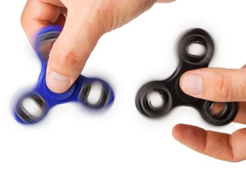 Playing with two Fidget Spinner Stock Photos
