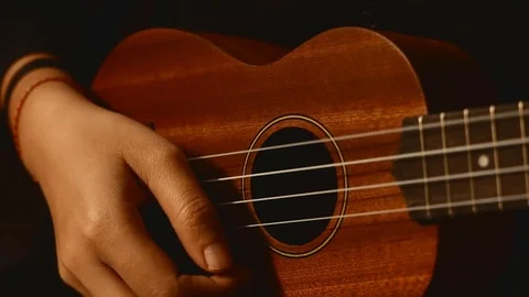Playing ukulele in close up view Stock Footage