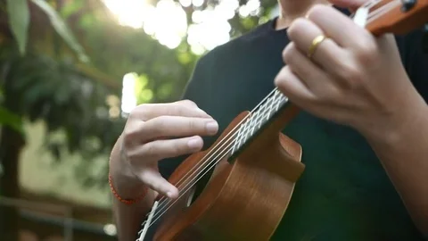 Playing ukulele in close up view Stock Footage 72563108
