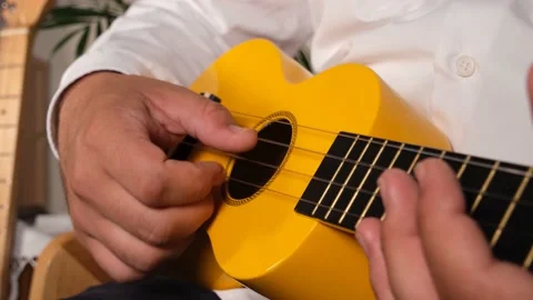 Playing the ukulele Stock Footage 197380458