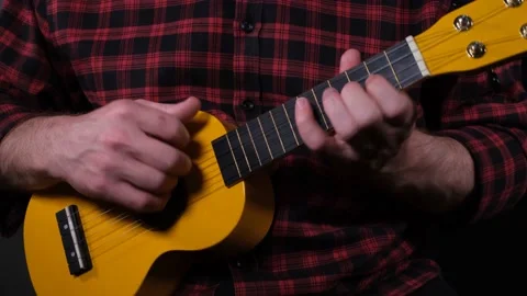 Playing ukulele instrument Stock Footage 228992121