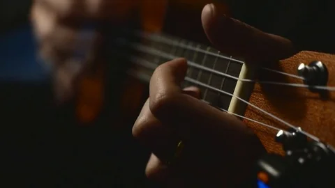 Playing ukulele shift focus Stock Footage 72407804