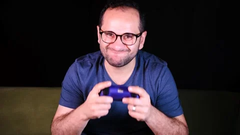 Playing video game using joystick Stock Footage 255611336