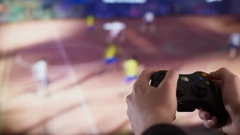 Playing video games with a controller in front of a tv Stock Footage 106379312