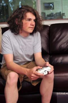Playing video games on the couch Stock Photos