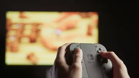 Playing video games on a gaming console with a controller Stock Footage 106379042