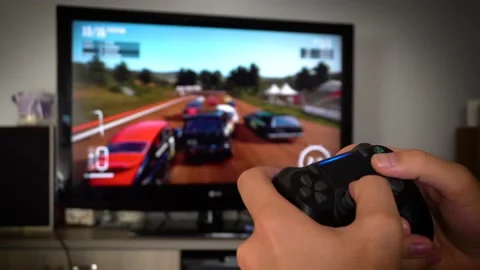 Playing video games racing on console Stock Footage 136329665