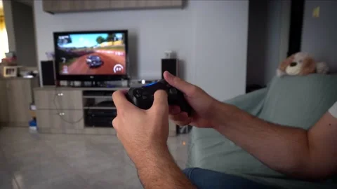 Playing video games racing on console Stock Footage 136329810