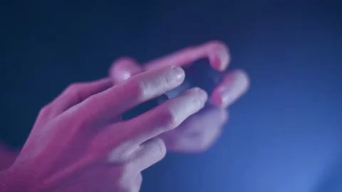 Playing video games on a small controller using triggers playing slowly Stock Footage 137780756