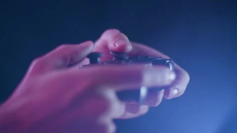 Playing video games on a small controller using joysticks playing quickly Stock Footage 137781453
