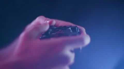 Playing video games on a small controller using joysticks playing slowly Stock Footage 137783667