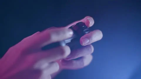 Playing video games on a small controller using triggers playing quickly Stock Footage 137783743