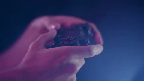 Playing video games small controller buttons facing camera playing slowly Stock Footage 137784446