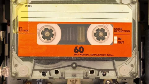 Playing vintage orange audio compact cassette Stock Footage 276427502