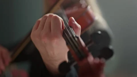 Playing the violin. Close-up of the musician's hands with selective focus. Stock Footage 298282053