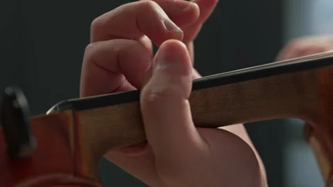 Playing the violin. Close-up of the musician's hands with selective focus. Stock Footage 298284960