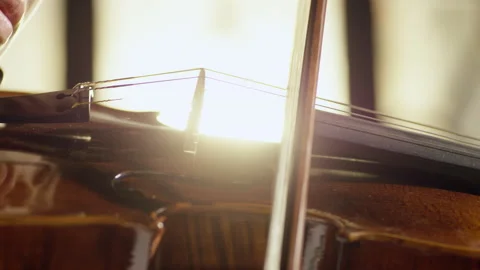 Playing Violin. Close Up Of Violin Bow Going Across Strings Stock Footage 133672228