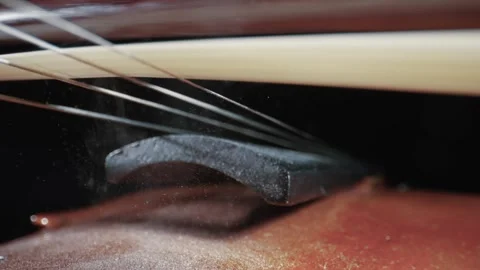 Playing violin over dark background in slow motion. Cinematic closeup shot Stock Footage 330118895