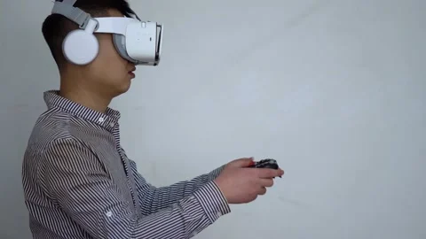 Playing VR games with VR handle to experience virtual reality Stock Footage 154453475