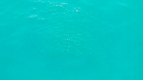 Playing in the waves of the Sea Slow motion over disturbed ocean water Stock Footage 130452887