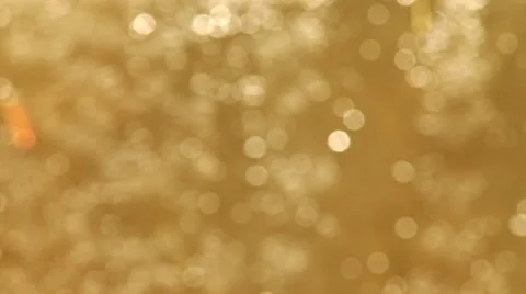 Playing waves of white large specks on light brown background. Stock Footage 46272130