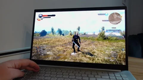Playing The Witcher 3 Wild Hunt Game on Laptop Stock Footage 237814167