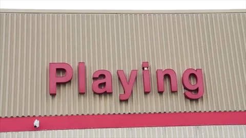 Playing word writing caption text on beige wall building above red line in red Stock Footage 249759652