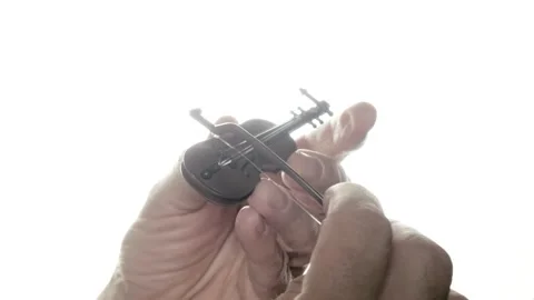 Playing the world's smallest violin: a humorous phrase to mock someone's Stock Footage 270110598