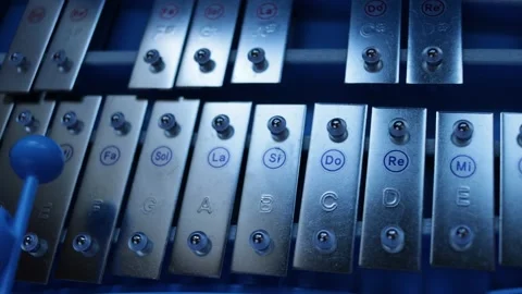Playing the xylophone in a nice blue light Stock Footage 144117228
