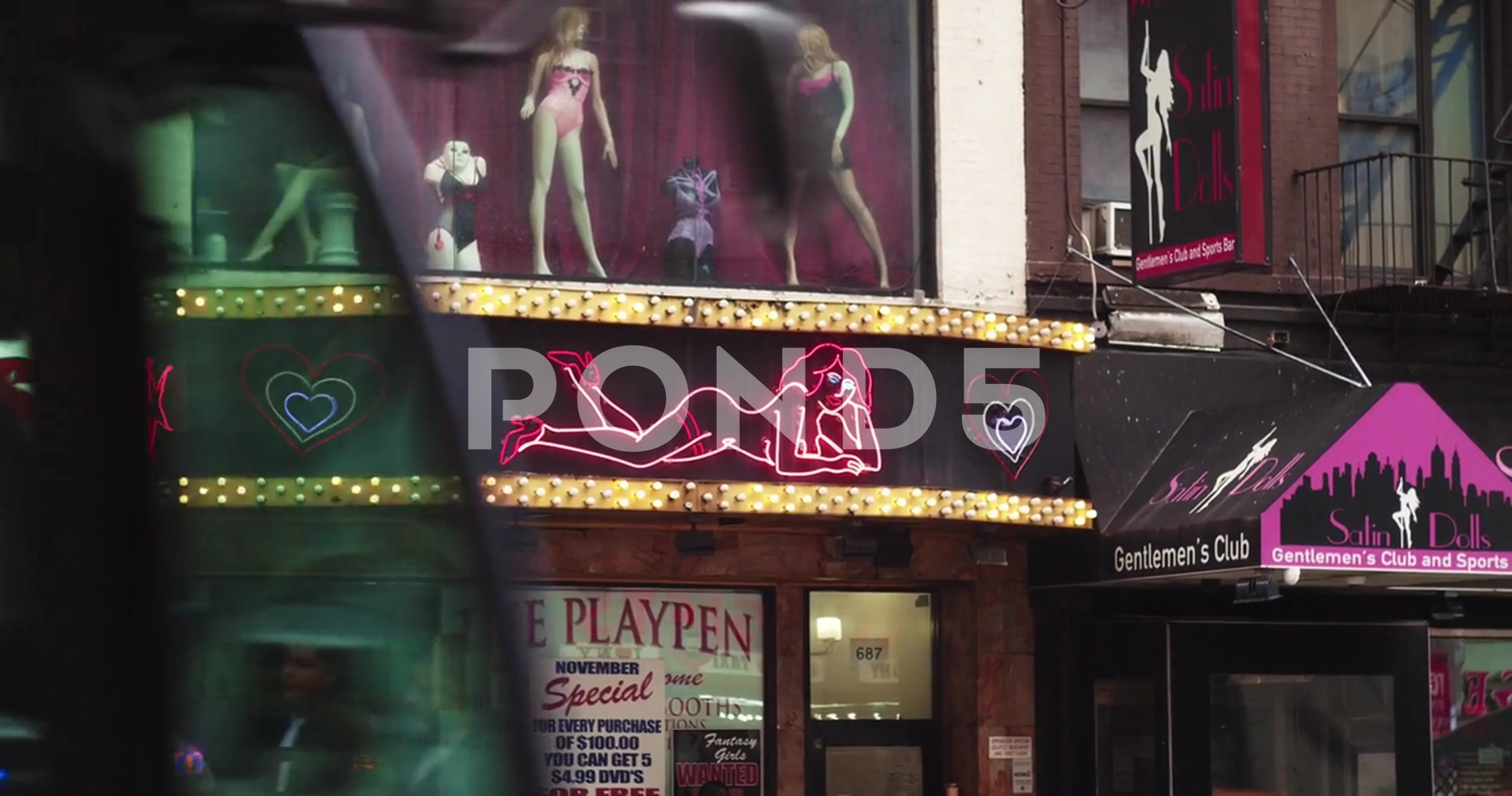 Playpen Sex Shop In Times Square NYC. Traffic passes in Front