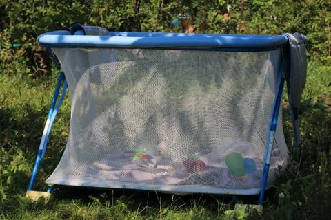 A playpen in the shade of the trees Stock Photos