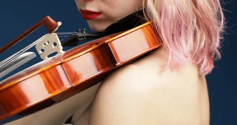 Plays classical music, focused, determined, blue background Stock Footage 239971252