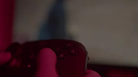 Plays a game on a gamepad Stock Footage 265176437