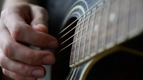 Plays the guitar closeup Stock Footage 92908811