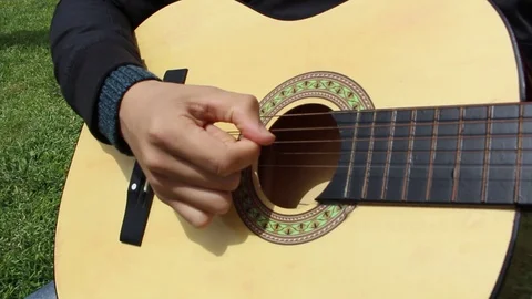 Plays the guitar Stock Footage 129530045