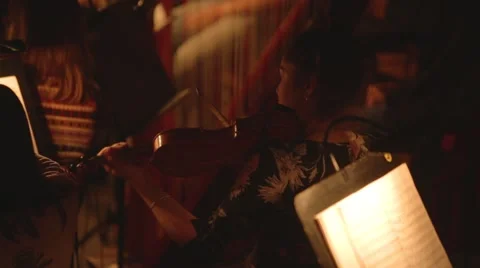 Plays on violin in orchestra pit Stock Footage 52803166