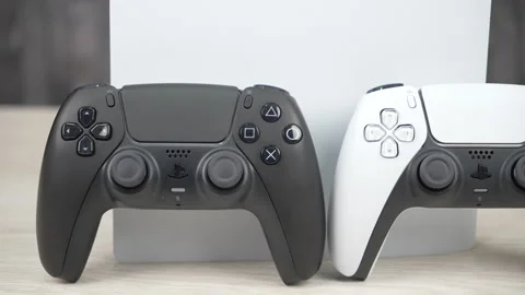 PlayStation 5 Console with Black and White DualSense Controllers on Desk Stock Footage 343907746