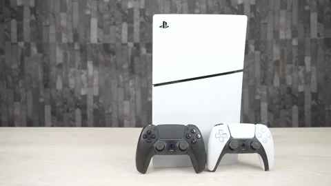 PlayStation 5 Console with Black and White DualSense Controllers on Desk Stock Footage 344038006