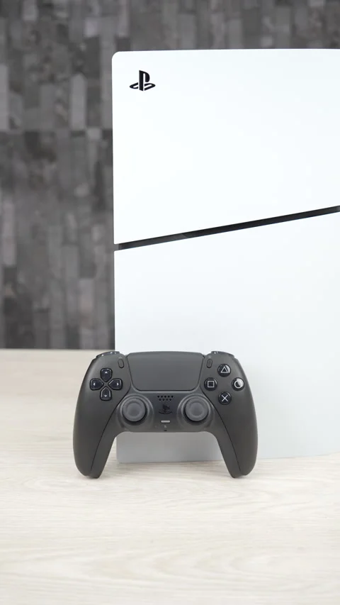 PlayStation 5 Console with Black and White DualSense Controllers on Desk Stock Footage 344038245