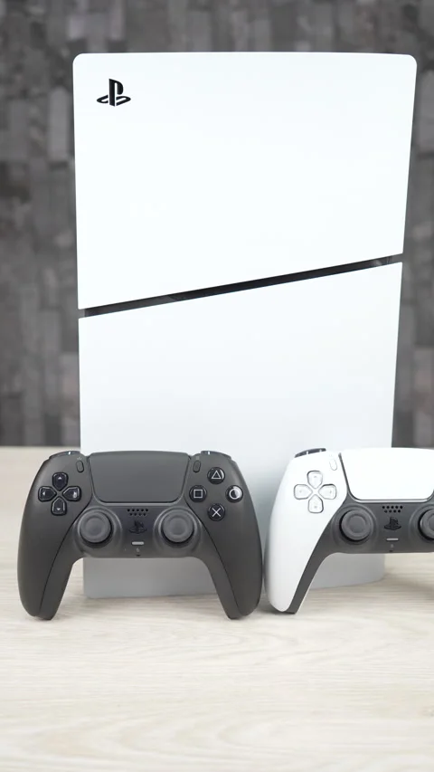 PlayStation 5 Console with Black and White DualSense Controllers on Desk Stock Footage 345049652