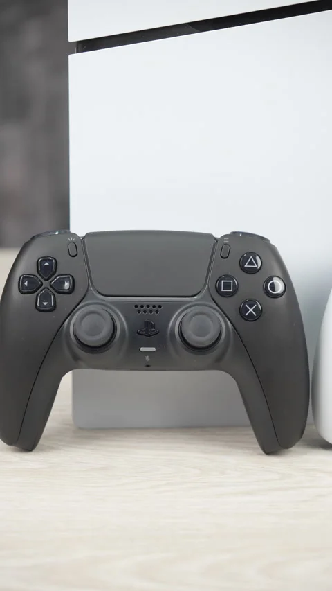 PlayStation 5 Console with Black and White DualSense Controllers on Desk Stock Footage 345049853