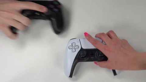 PlayStation 5 DualSense controller and PlayStation 4 DualShock 4 controller Video stock 233884943