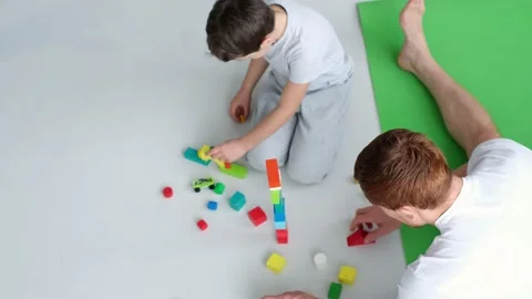 Playtime. kid boy and father play builders in nursery at home. dad playing Stock Footage