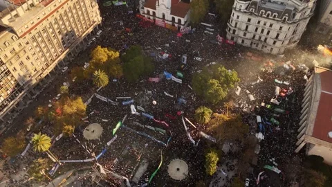 Plaza de Mayo filled with massive protest crowd and colorful banners flanking Stock Footage 336432911