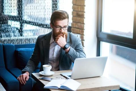 Pleasant bearded man drinking coffee Stock Photos