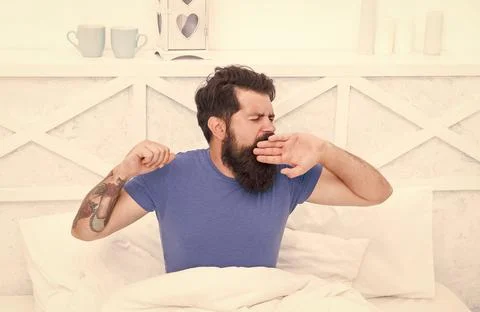 Pleasant bed time routine. brutal male spending time in room. relax lifestyle Foto stock