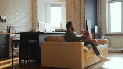 A pleasant evening of a young single man in the company of his best friend dog Stock Footage 233429499